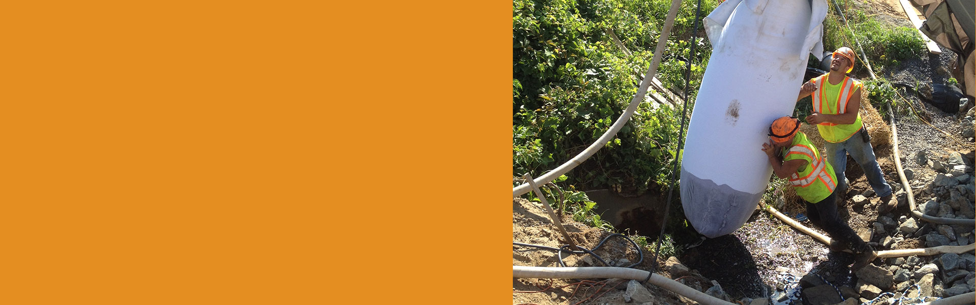 Slider background of Two construction workers holding up heavy item